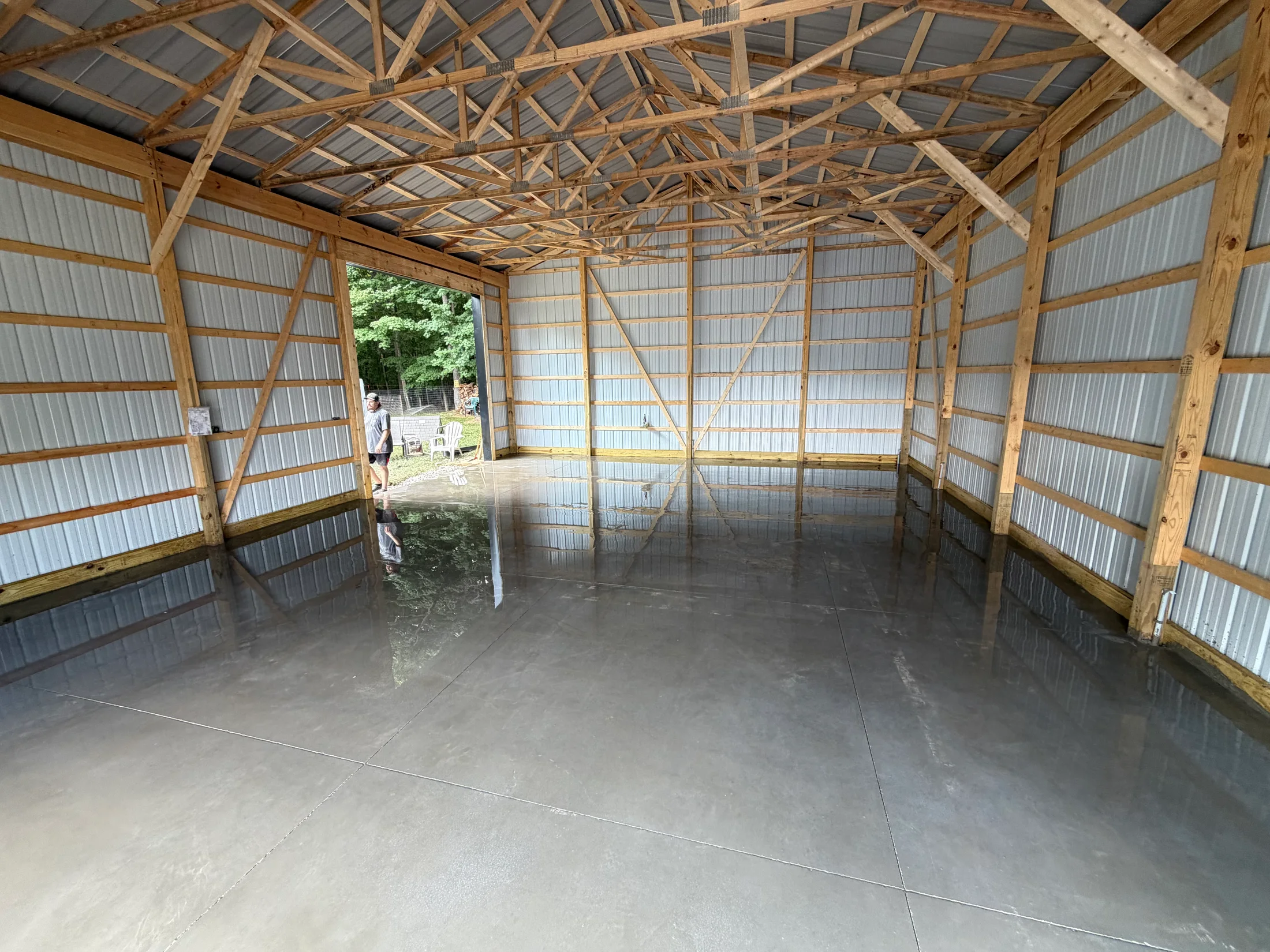 Concrete floor inside a timber-framed barn.