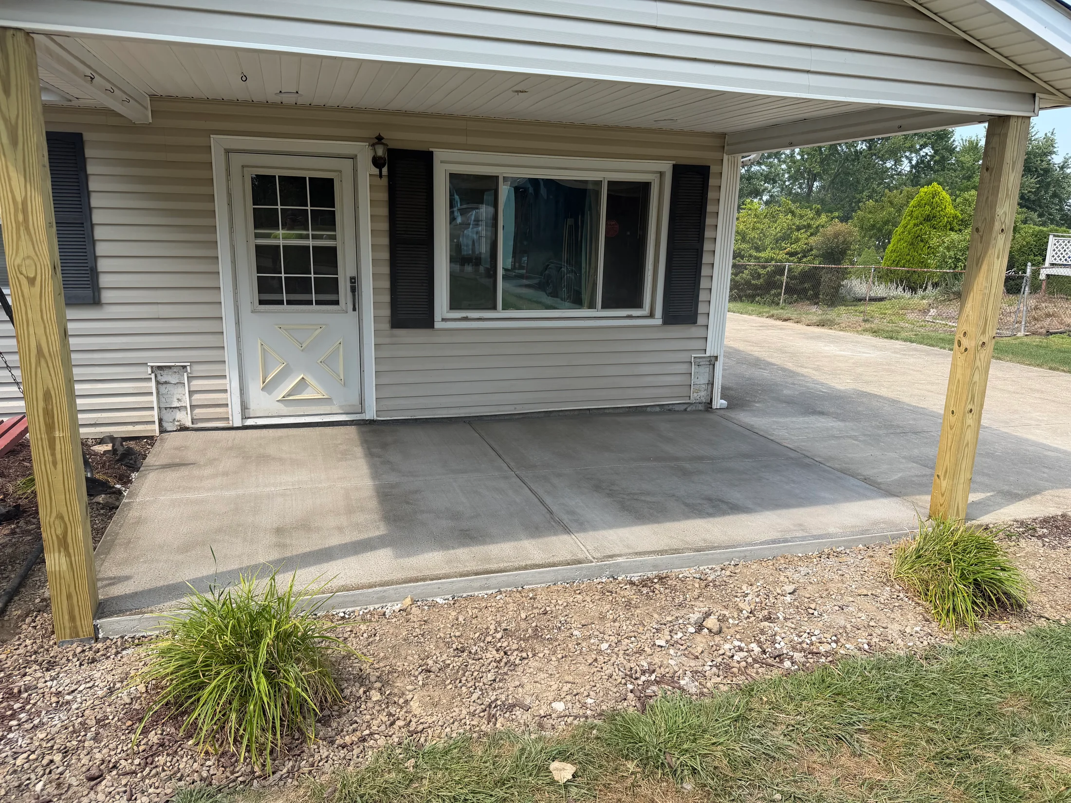 Concrete porch surface beneath a covered entry.