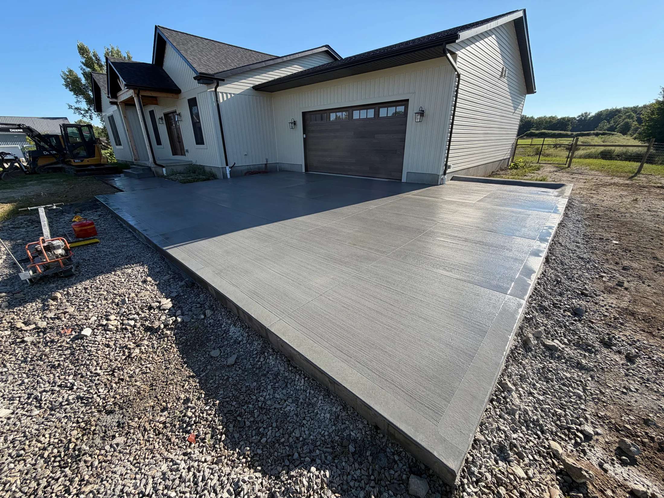 Concrete garage apron with a connected front-entry walkway.