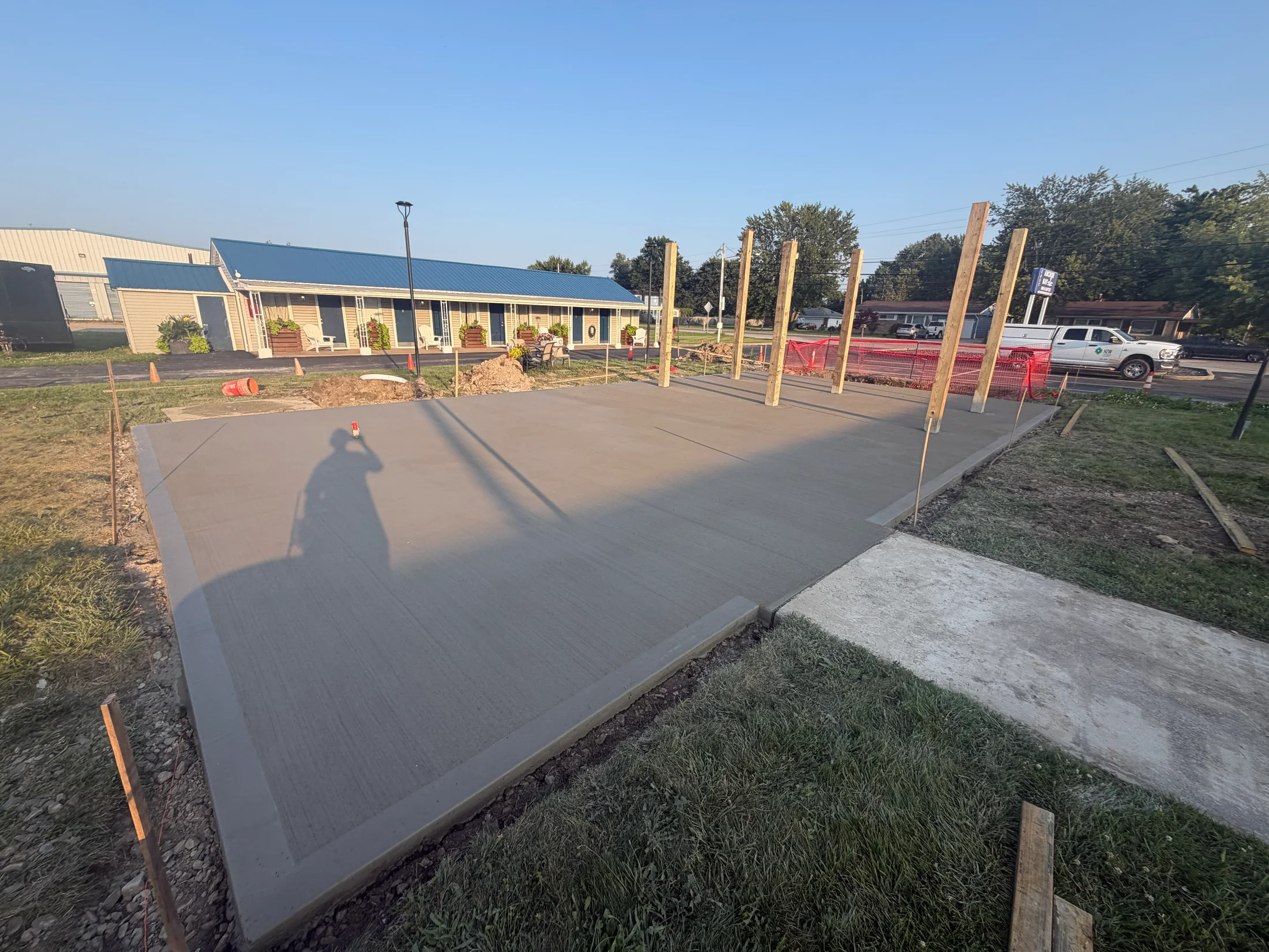 Outdoor concrete slab with upright timber posts.